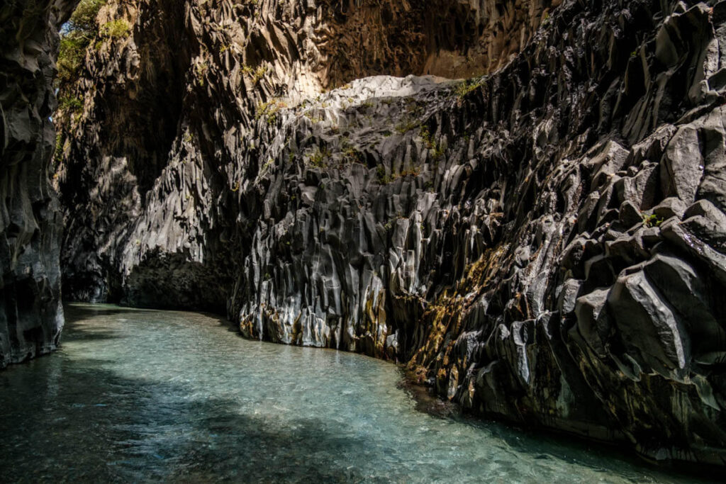 Walking in waters of Gole Alcantara Sicily travelinmypocket